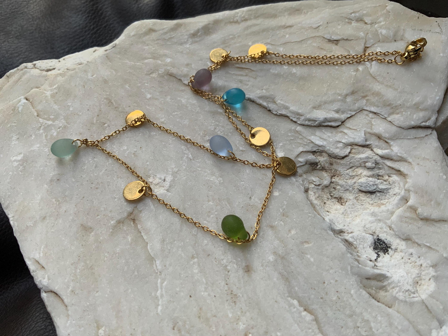 Gold chain necklace with pastel sea glass beads and round coin charms, handcrafted in Greece. A lightweight, minimalist design perfect for adding a touch of elegance to any outfit.