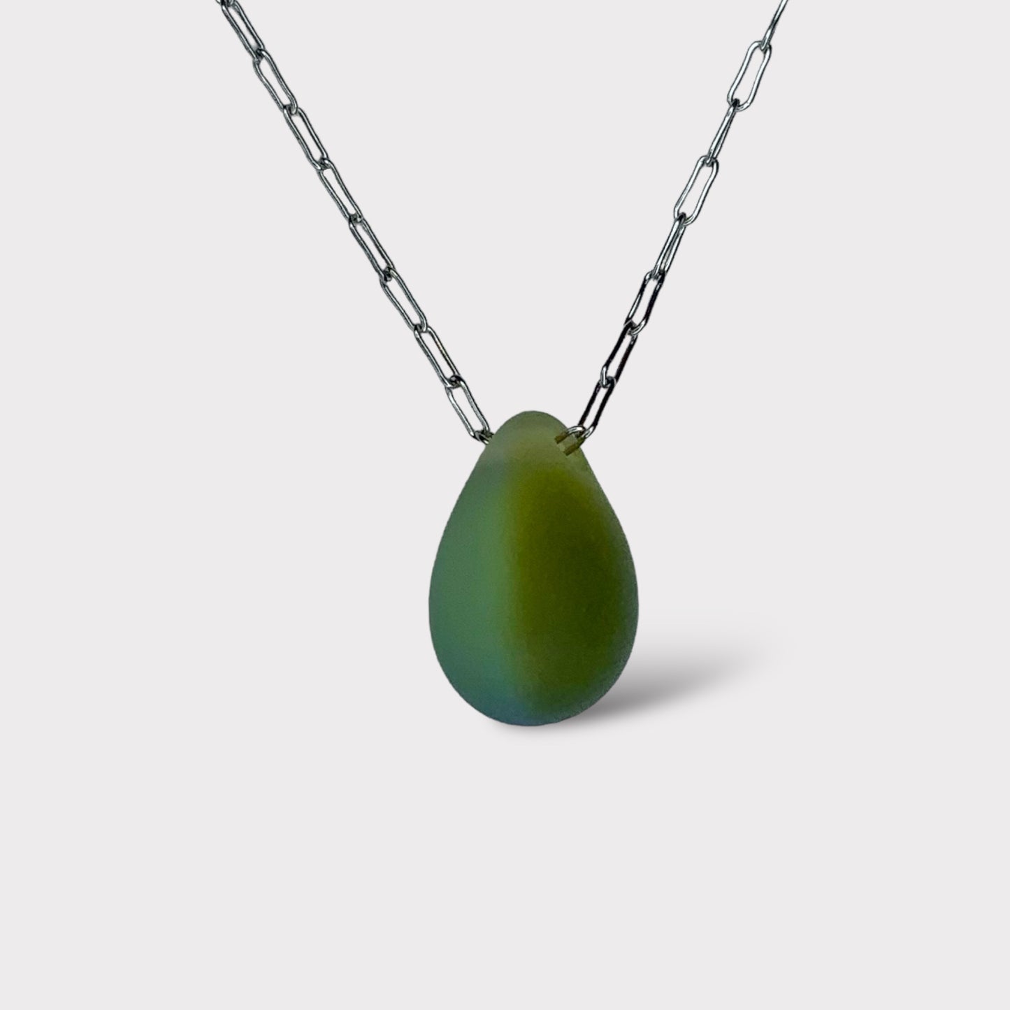 A warm gold olive matte teardrop-shaped glass pendant, hanging from a stainless steel chain, displayed on a white background for a unique and modern design.