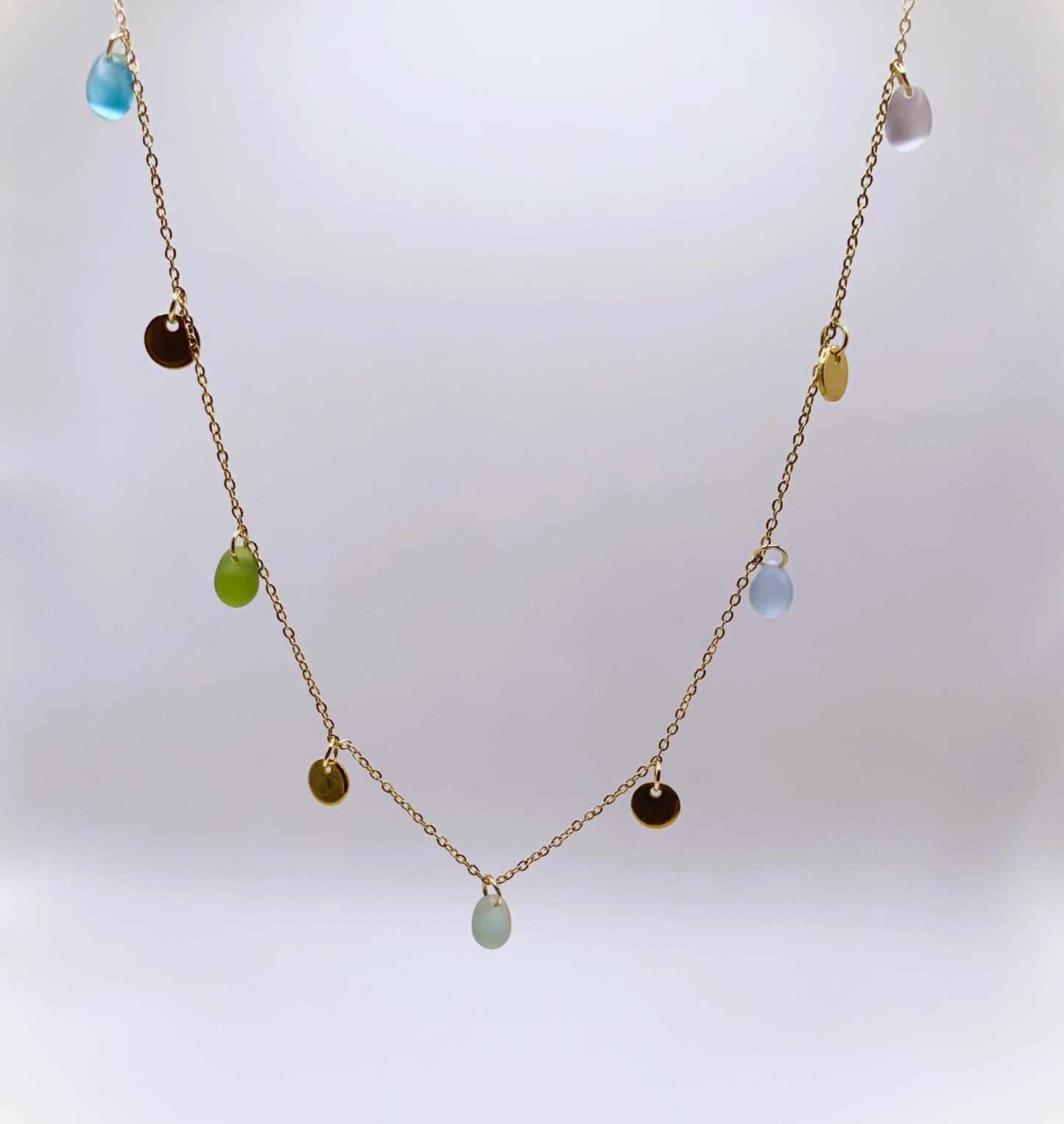 Greek-inspired necklace with colorful glass beads on gold and coin accents, a minimalist design perfect for layering or wearing solo. Handcrafted in Greece for greek summer vibes.