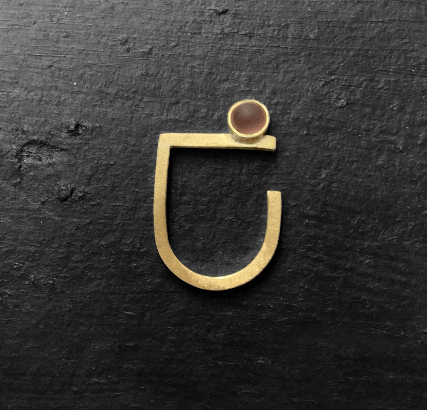 Minimalist gold ring with a frosted peach matte glass accent, designed for a modern sleek look.
