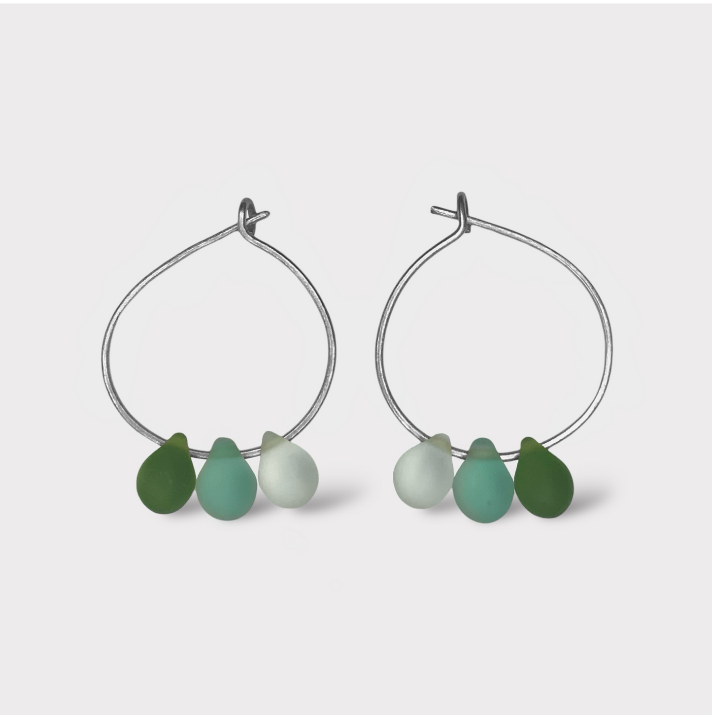 Refreshing silver hoop earrings with seaglass charms in mint green and seafoam hues. A clean and modern design inspired by the cool taste of mint and matcha.