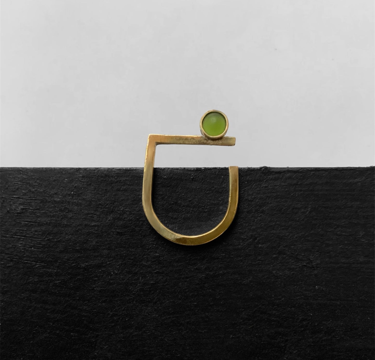 Handcrafted gold ring featuring a frosted green glass accent, designed for a sleek and contemporary look.