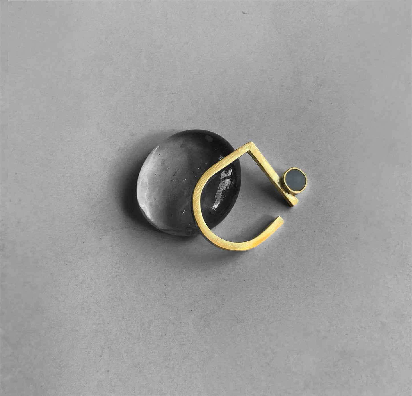Handcrafted gold ring with a frosted blue glass accent. Inspired by minimalist modern greek art.