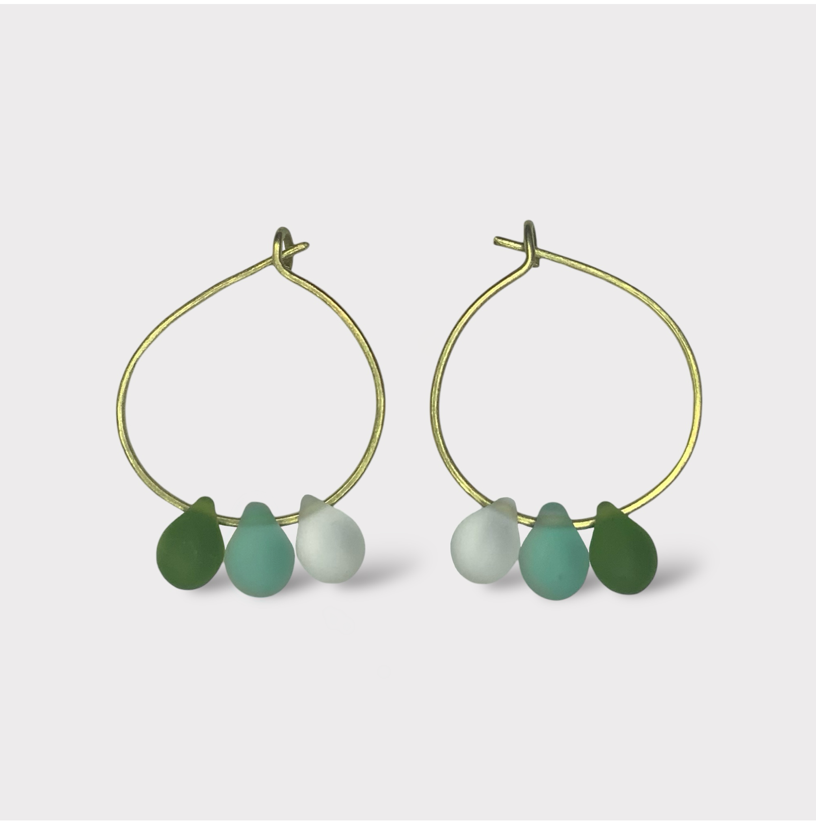 gold-minimalist-small-hoop-earrings-with-matte-frosted-glass-teardrop-beads-in-pastel-colors-white-background-product-photo-jewelry-by-meow-iris-collection-arsinoe-mint-matcha-earrings-greek-handmade-summer-jewelry