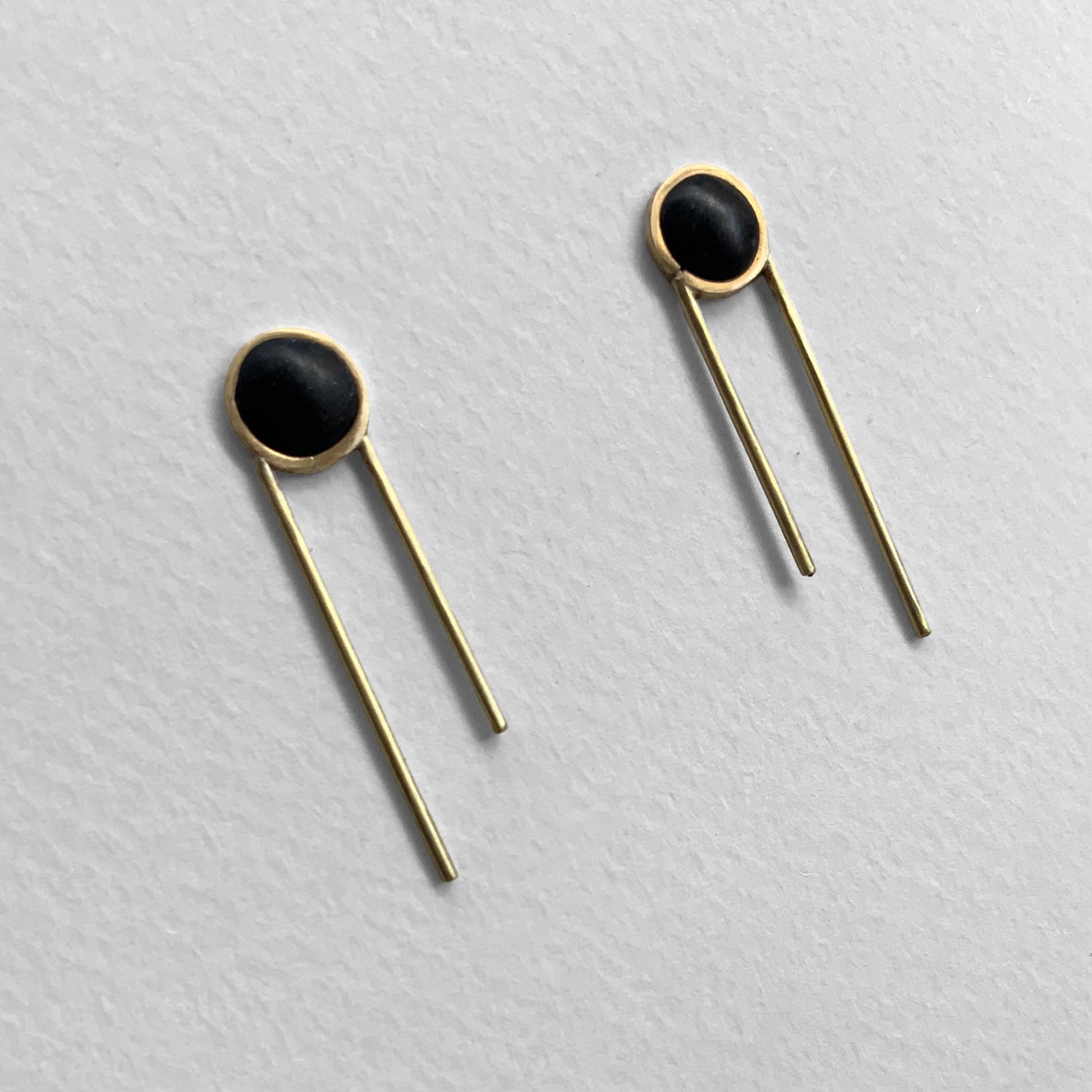 Front view, Modern earrings, Minimalist earrings, Black and gold earrings, Geometric earrings, Contemporary jewelry, Long bar earrings, Circle earrings, Stylish earrings, Unique earrings design, Fashion accessories, Elegant earrings, Designer earrings, Trendy jewelry, Statement earrings, Handcrafted earrings