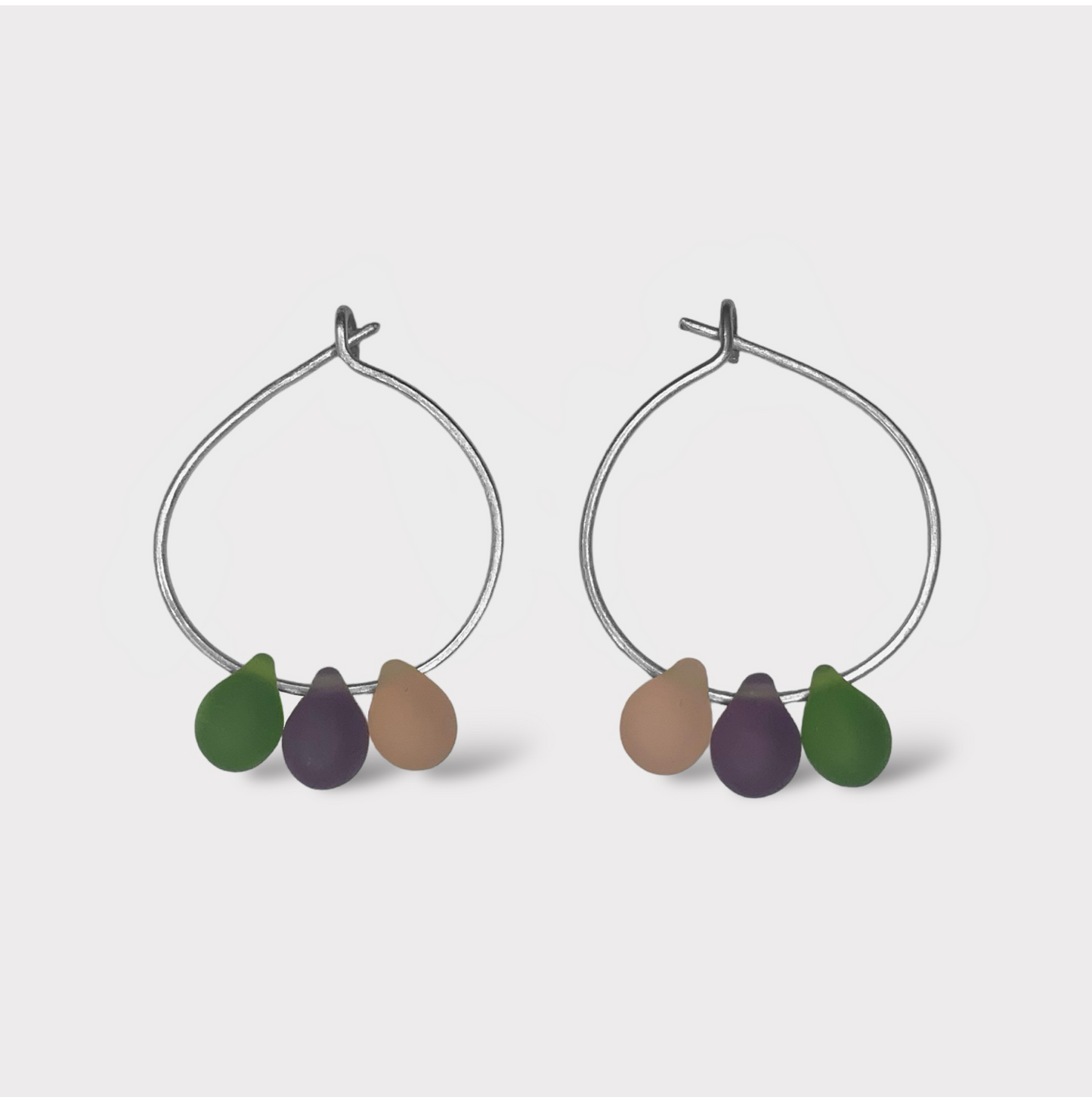 Handcrafted silver hoop earrings with smooth seaglass charms in plum purple, soft lavender, and mint green. A whimsical design inspired by the pastel tones of mochi desserts.