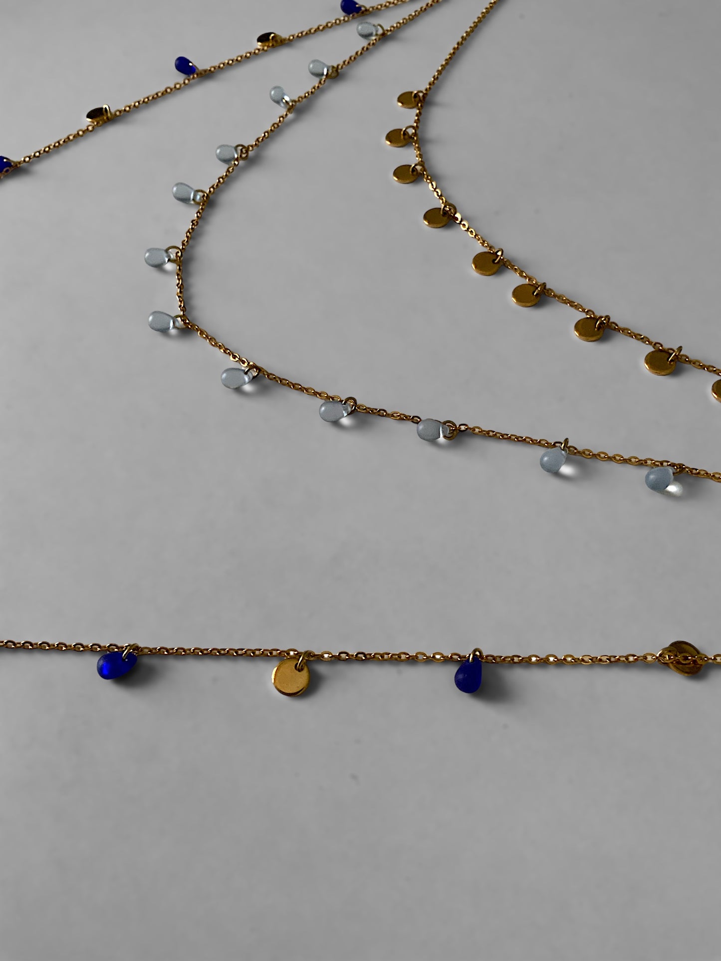 long-layered-boho-gold-chain-necklace-with-royal-and-sky-blue-sea-glass-beads-and-golden-pendant-coin-charms--jewelry-by-meow-iris-necklaces-boho-necklaces-layered-sea-glass-charm-necklace