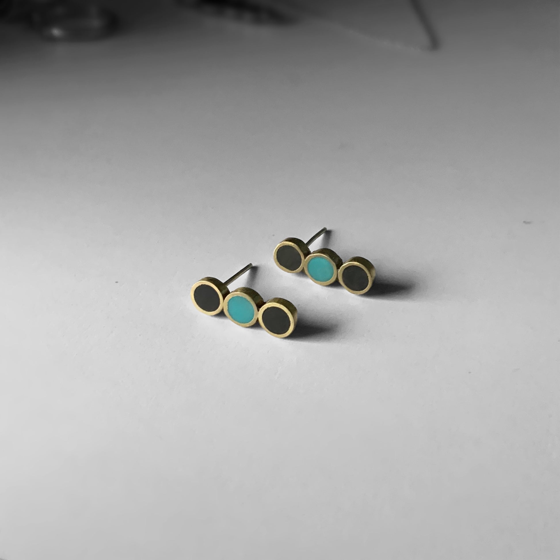 right-top-angle-handmade-artisan-greek-medium-minimalist-stud-earrings-with-three-circle-shapes-with-black-and-turqoise-poymer-clay-inlay-on-white-surface-jewelry-by-meow-dusk-and-dawn-collection-focal-studs