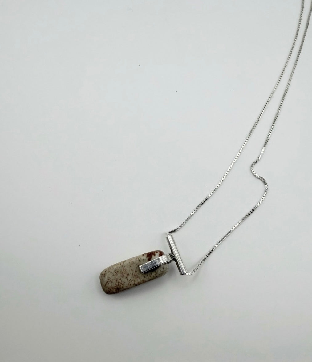 Sterling silver landscape jasper necklace shown at an angle with box chain and stone pendant on a white background