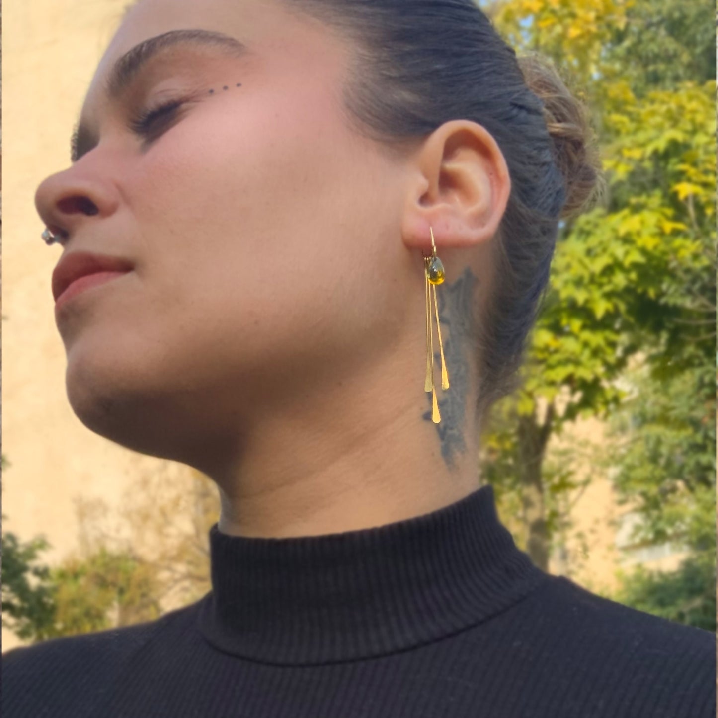 closeup-of-girl-wearing-contemporary-ear-jackets-with-long-hammered-golden-lines-and-iridescent-glass-teardrop-beads-jewelry-by-meow-iris-collection-artemisearrings-greek-handmade-modern-elegant-jewelry